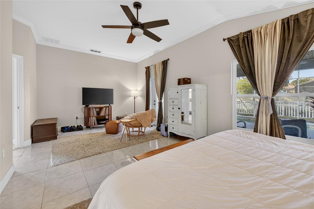 1864 Orange Tree Drive Edgewater, FL 32141 - Photo 24 of 38 a bedroom with a bed and a television