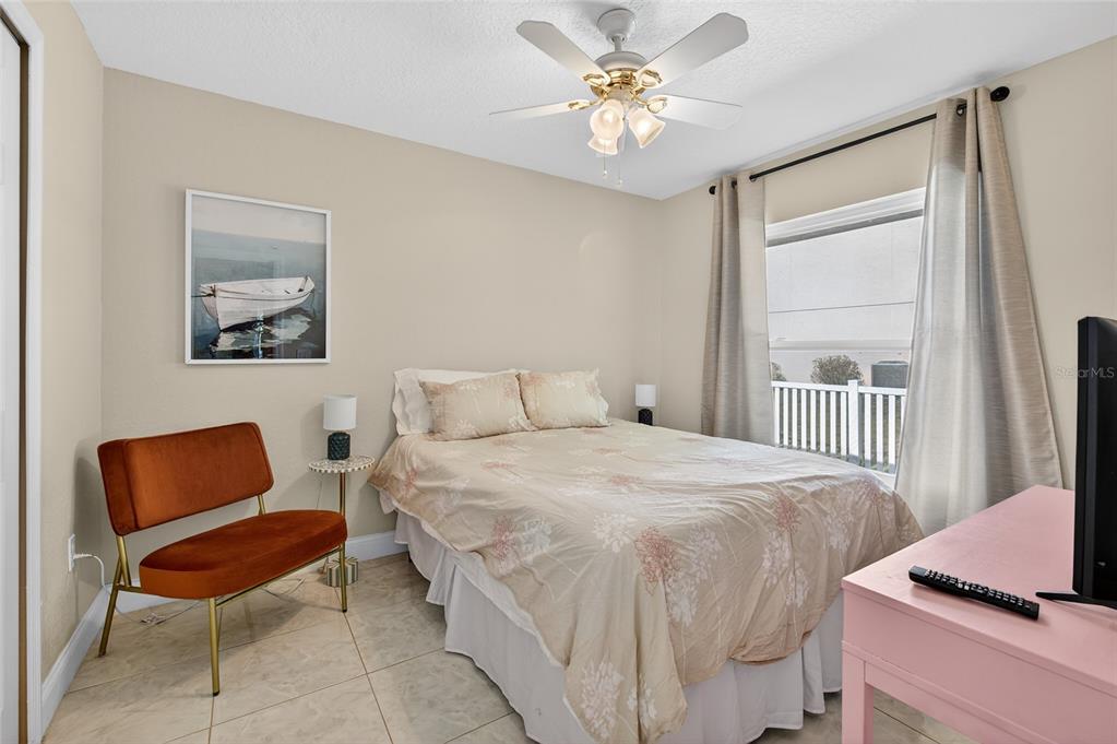 1864 Orange Tree Drive Edgewater, FL 32141 - Photo 37 of 38 a bedroom with a bed and chair