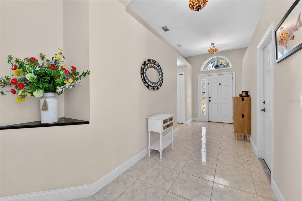 1864 Orange Tree Drive Edgewater, FL 32141 - Photo 8 of 38 a view of entryway with paintings on the wall