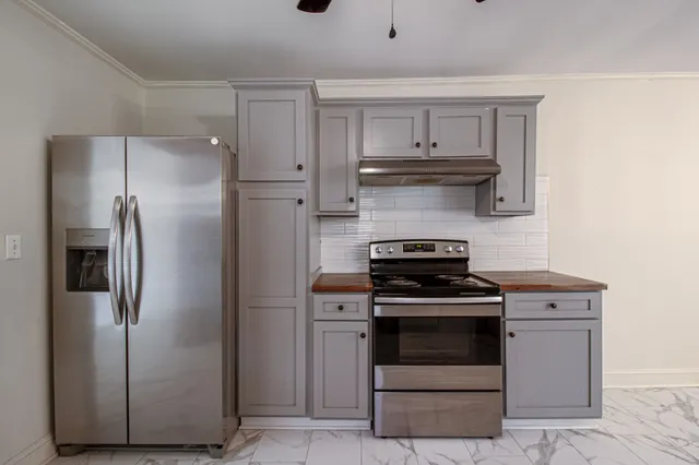 a kitchen with a stove and a refrigerator