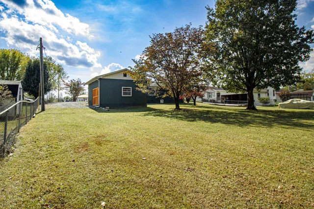 a swimming pool with outdoor seating and yard