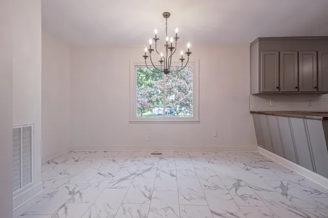 a view of kitchen with window and chandelier