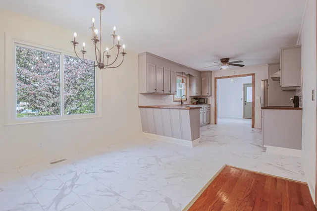 a large kitchen with cabinets and wooden floor
