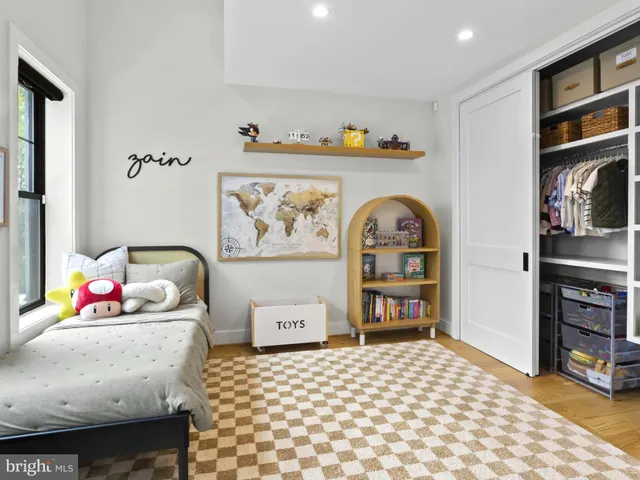 a bedroom with a bed and a dresser in it