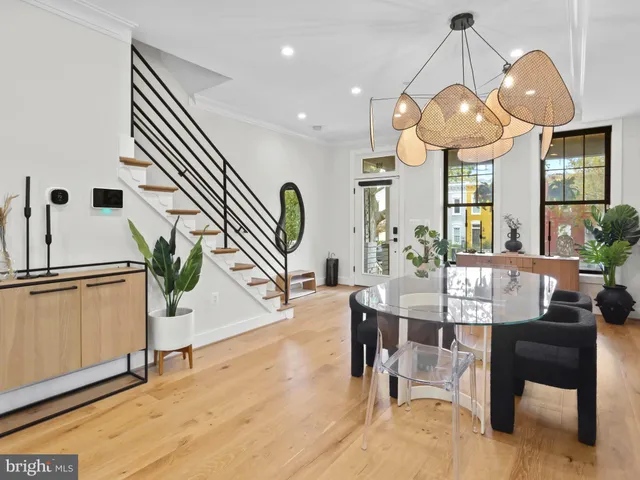 a view of a dining room with furniture wooden floor and chandelier