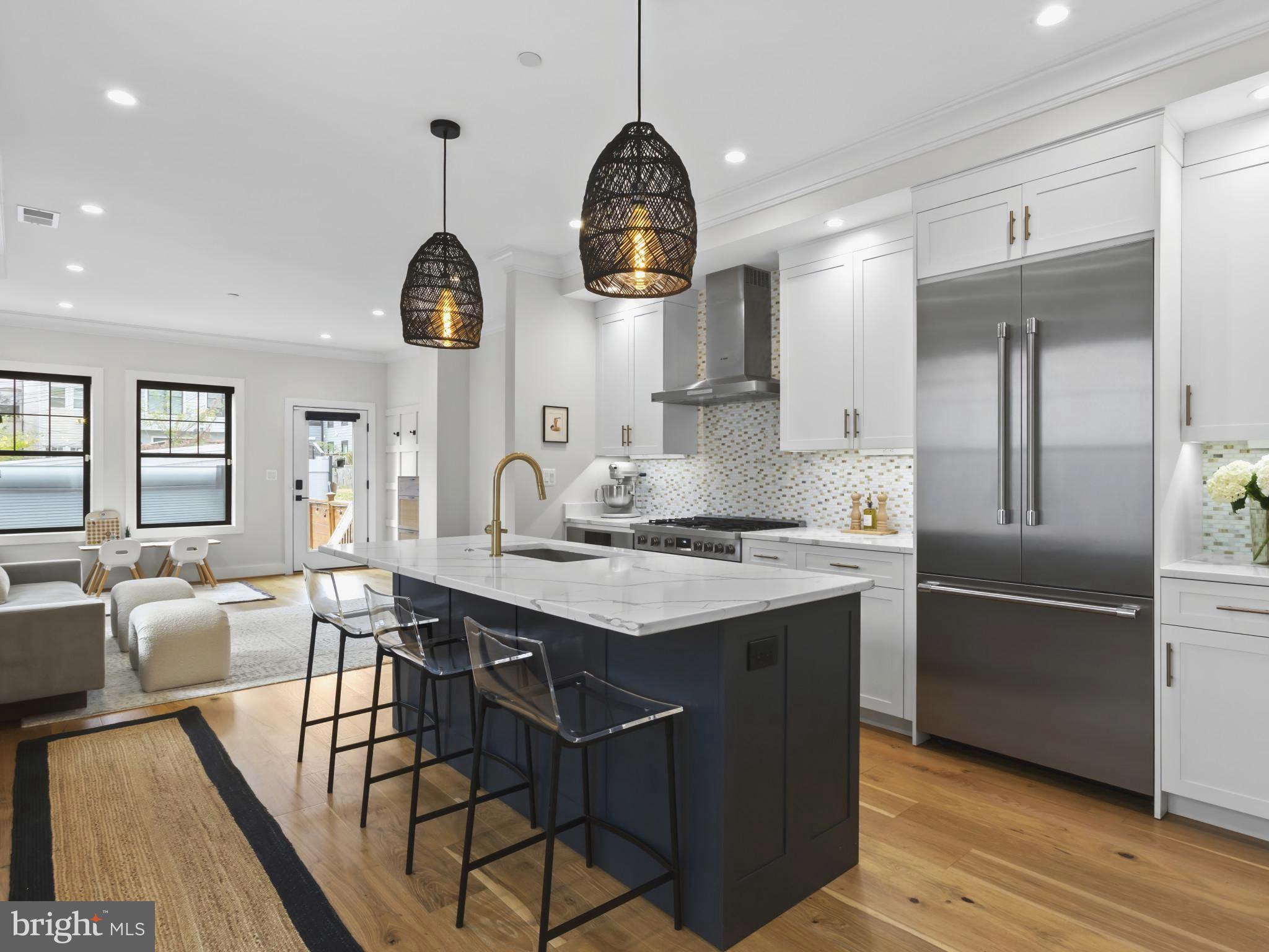 910 8th Street Northeast Washington, DC 20002 - Photo 10 of 54 a kitchen with stainless steel appliances granite countertop a sink stove and refrigerator