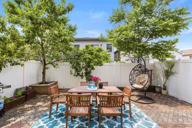 a backyard of a house with table and chairs