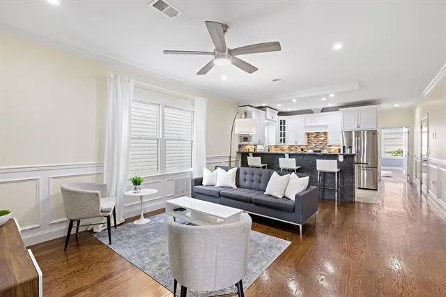 a living room with furniture and kitchen view