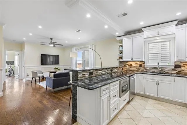 a kitchen with stainless steel appliances granite countertop a stove and a sink