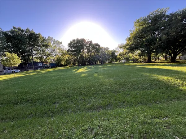 a backyard of a house with lots of green space and outdoor seating