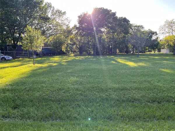 a view of yard with swimming pool and trees