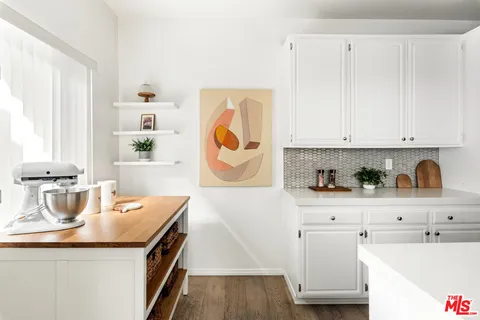 a kitchen with stainless steel appliances granite countertop a sink and dishwasher with white cabinets