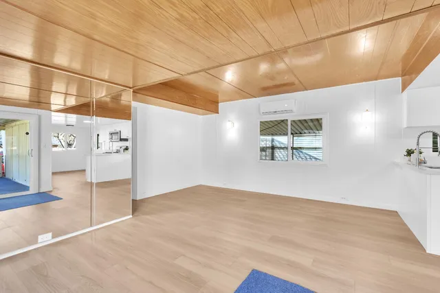 a view of a room with wooden floor
