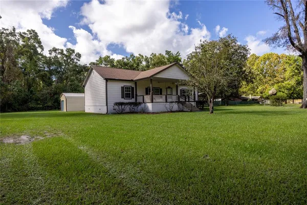 a view of a house with a yard