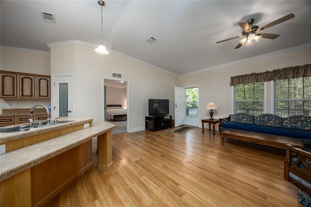 1759 Northeast 127th Street Branford, FL 32008 - Photo 11 of 45 a living room with furniture a fireplace and a flat screen tv