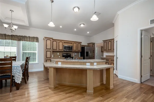 a large kitchen with stainless steel appliances kitchen island granite countertop a large island in the center