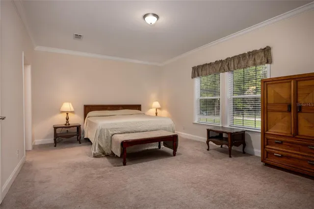 a bed room with a bed and a chair