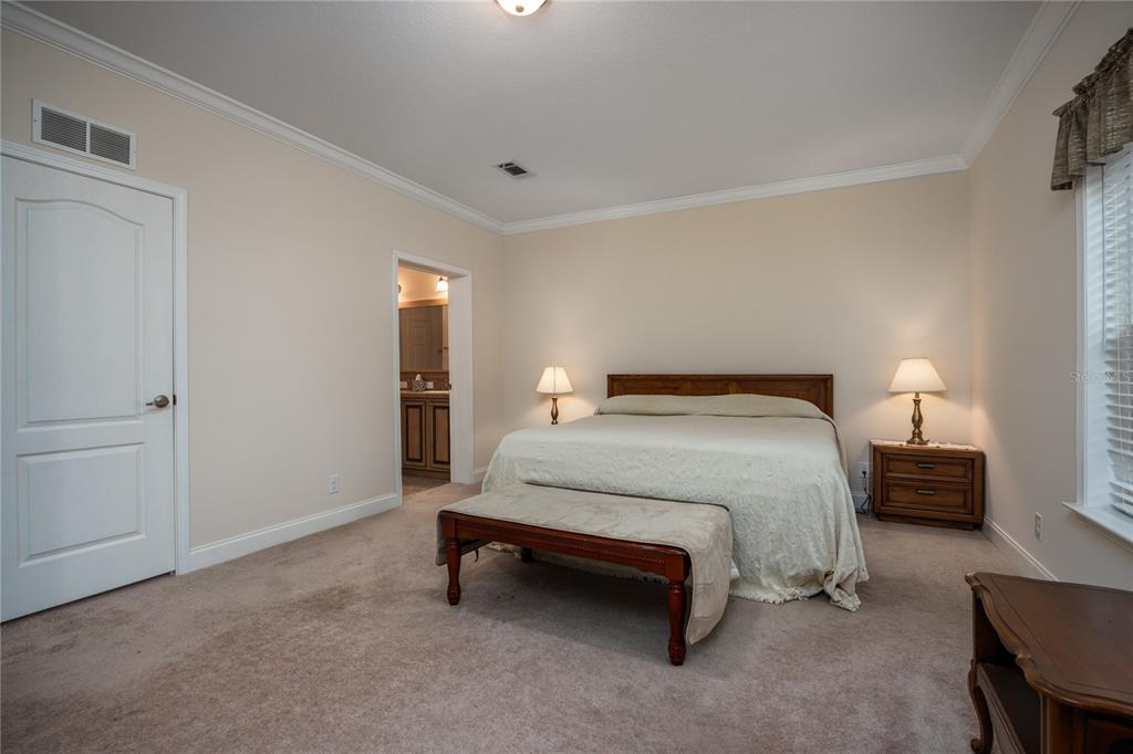 1759 Northeast 127th Street Branford, FL 32008 - Photo 19 of 45 a spacious bedroom with a bed and a lamp