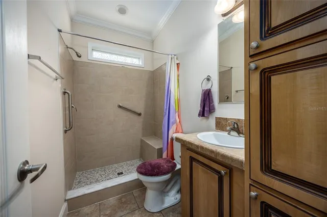 a bathroom with a sink toilet and shower