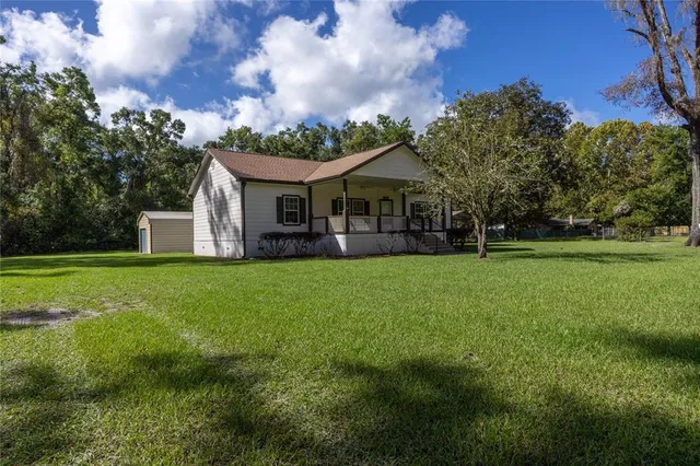 a front view of house with yard and green space
