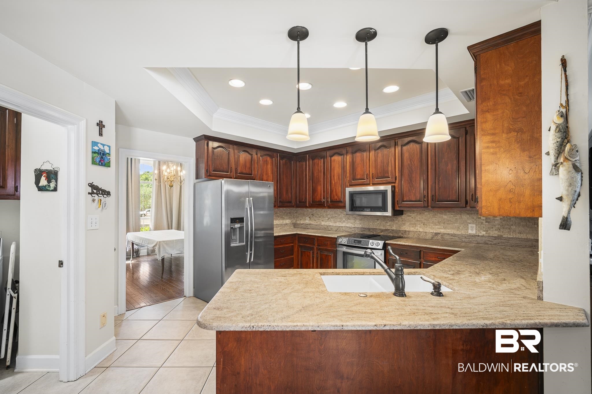 402 Potters Mills Road Daphne, AL 36526 - Photo 10 of 45 Kitchen with appliances with stainless steel finishes, a peninsula, a sink, tasteful backsplash, and hanging light fixtures