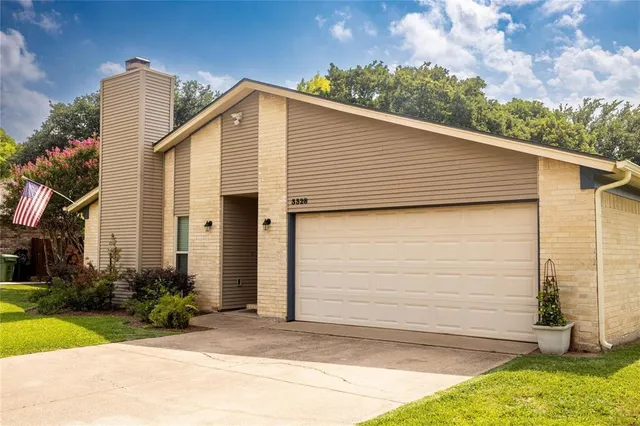 a view of a house with a yard and garage