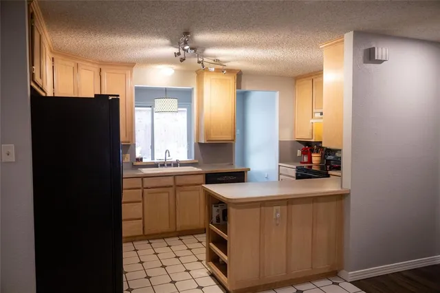 a kitchen with a sink stove and refrigerator