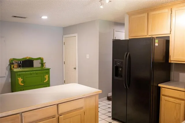 a kitchen with a refrigerator and a cabinets