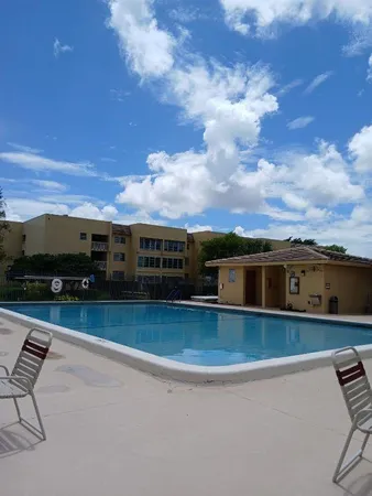 a view of a swimming pool with a yard