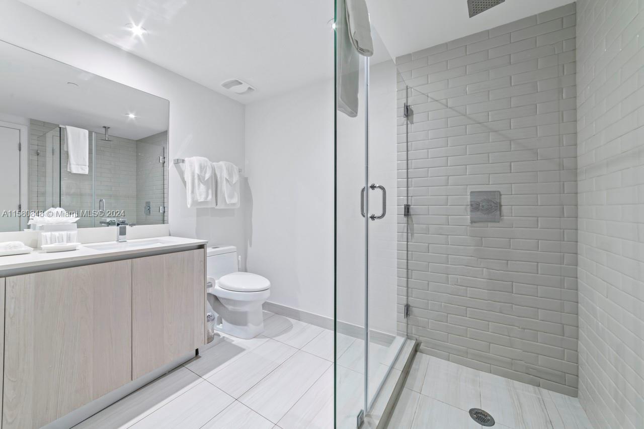 4010 South Ocean Drive, Unit R2505 Hollywood, FL 33019 - Photo 12 of 25 a bathroom with a granite countertop sink toilet and shower