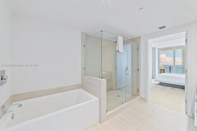 a bathroom with a bathtub and a shower