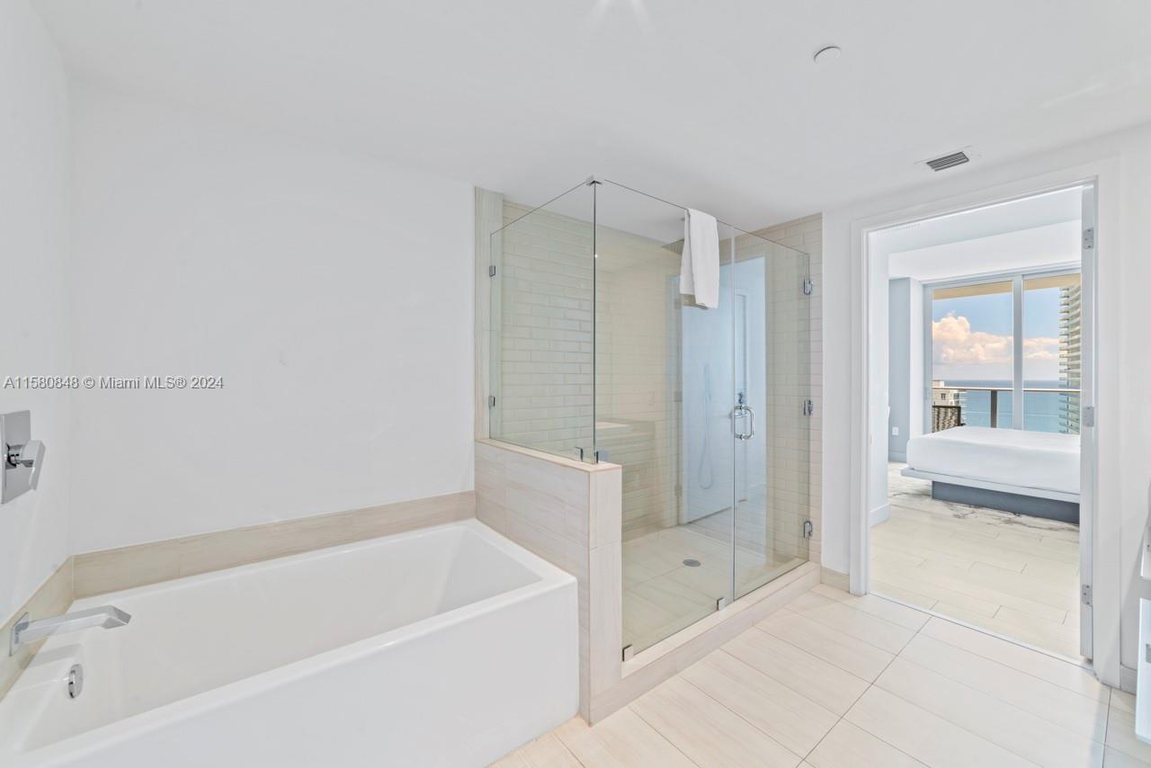 4010 South Ocean Drive, Unit R2505 Hollywood, FL 33019 - Photo 18 of 25 a bathroom with a bathtub and a shower