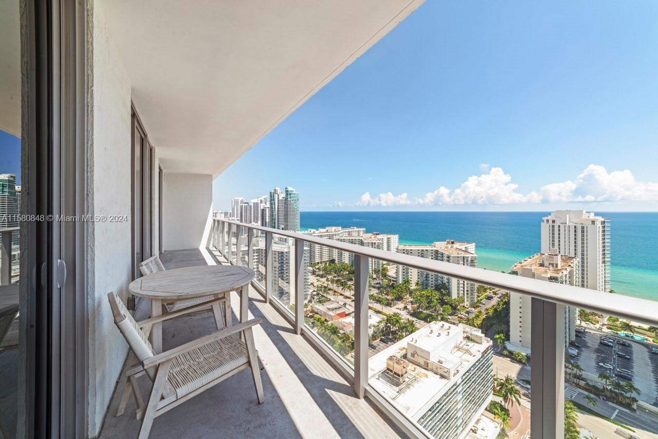 4010 South Ocean Drive, Unit R2505 Hollywood, FL 33019 - Photo 20 of 25 a view of a balcony with wooden chairs