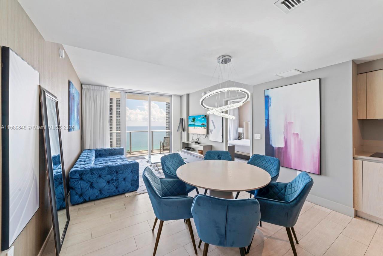 4010 South Ocean Drive, Unit R2505 Hollywood, FL 33019 - Photo 3 of 25 a view of a dining room with furniture and a chandelier