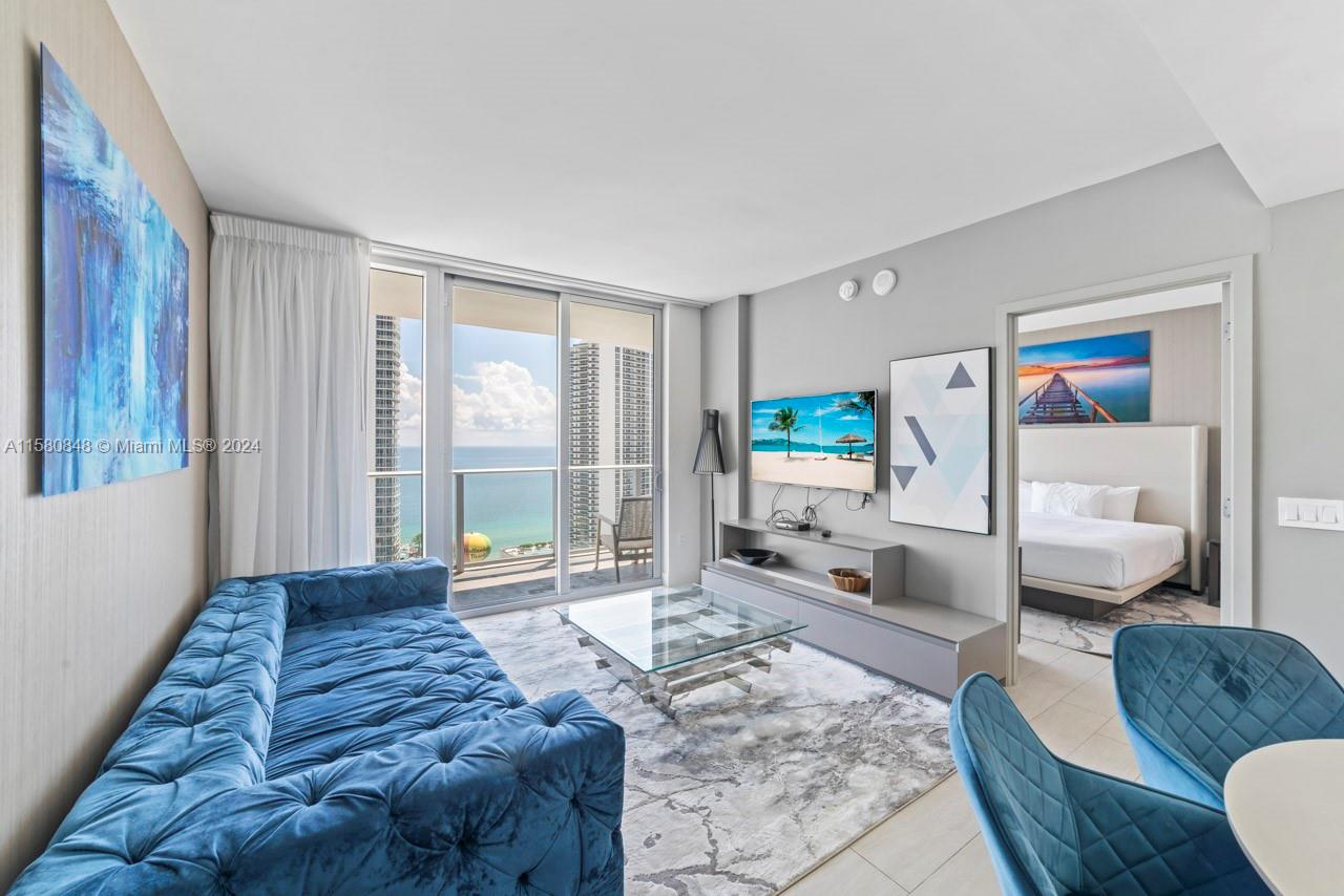 4010 South Ocean Drive, Unit R2505 Hollywood, FL 33019 - Photo 4 of 25 a spacious bedroom with a bed a couch and a window