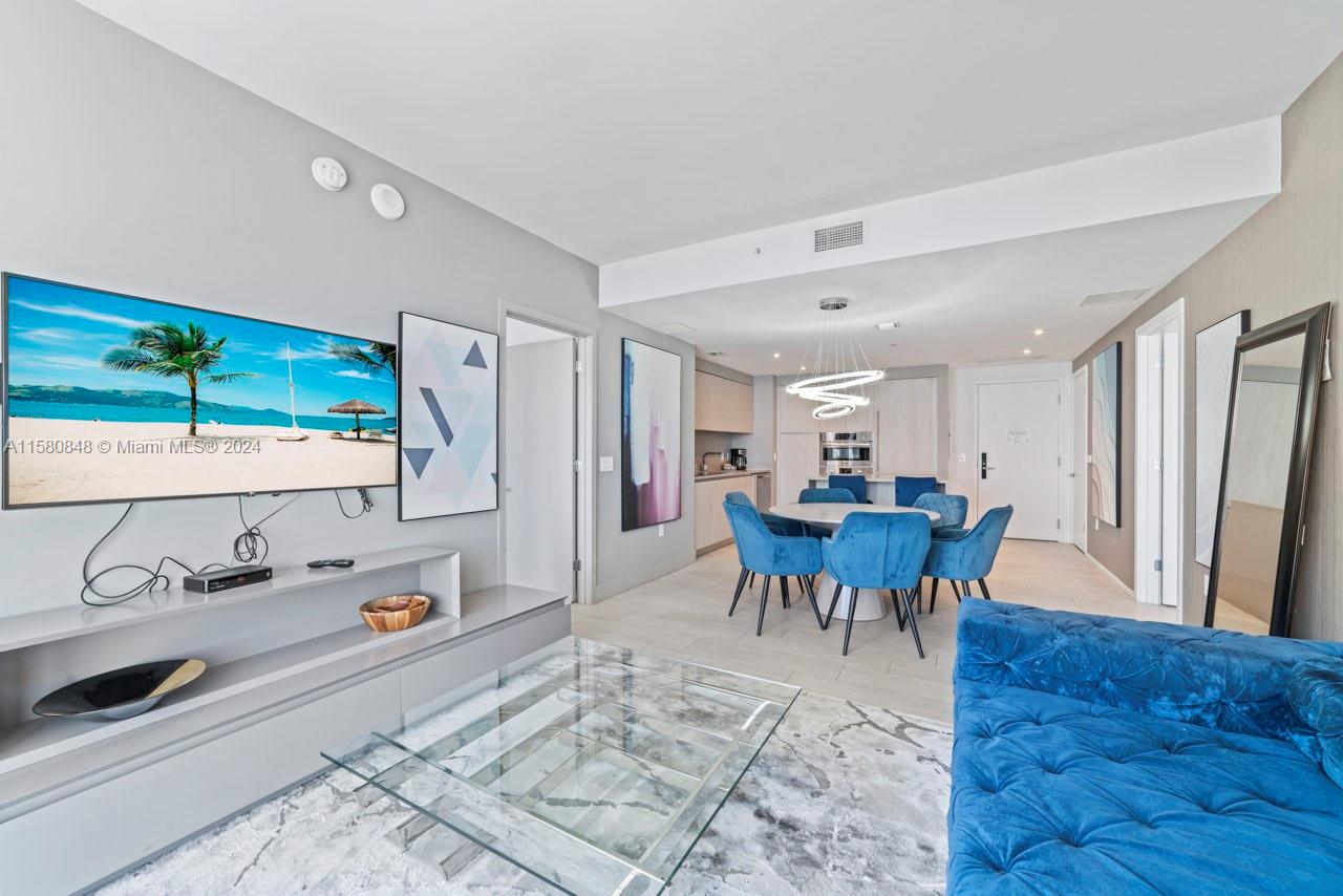 4010 South Ocean Drive, Unit R2505 Hollywood, FL 33019 - Photo 8 of 25 a living room with furniture and a table