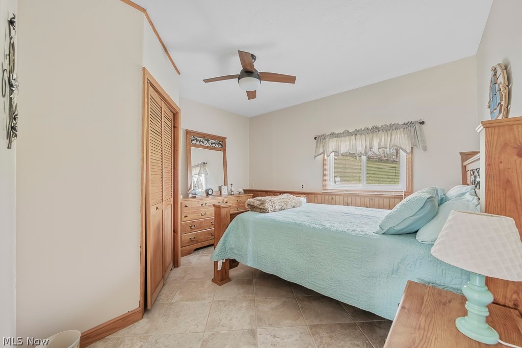 6939 Lakeview Road Hanoverton, OH 44423 - Photo 25 of 42 Bedroom with a closet, ceiling fan, and light ceramic tile flooring