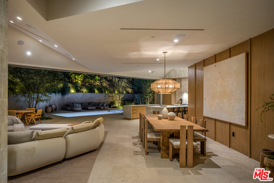 1600 Rising Glen Road Los Angeles, CA 90069 - Photo 14 of 28 a view of a dining room with furniture a chandelier and a large window