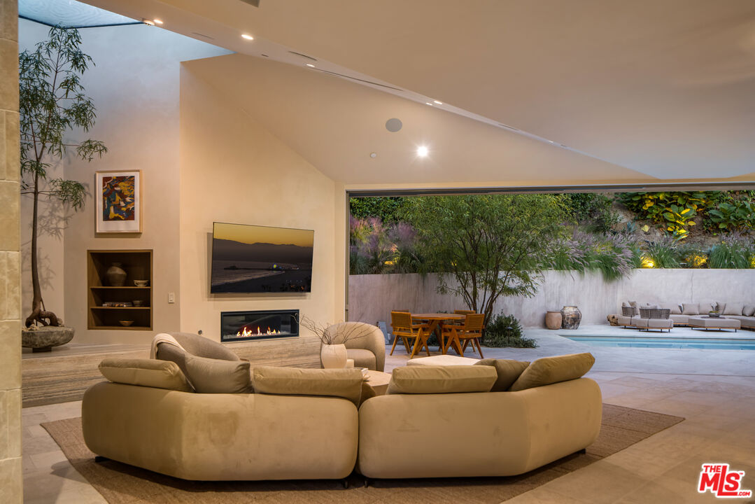 1600 Rising Glen Road Los Angeles, CA 90069 - Photo 15 of 28 a living room with furniture and a flat screen tv