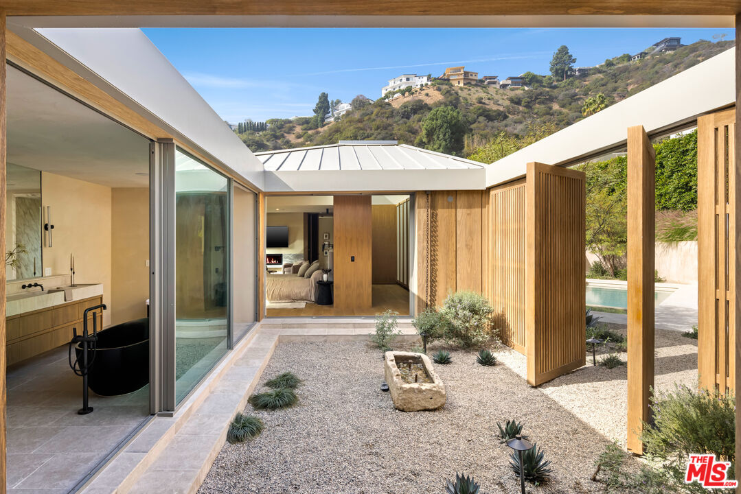 1600 Rising Glen Road Los Angeles, CA 90069 - Photo 20 of 28 a view of a porch with furniture and floor to ceiling window