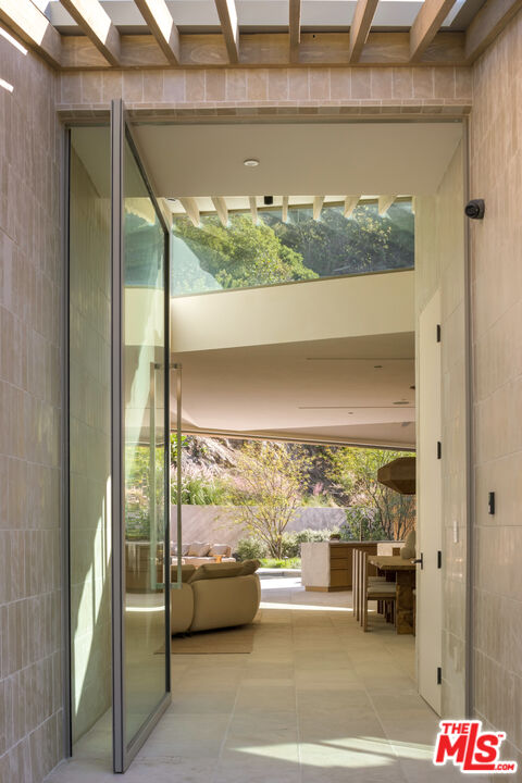 1600 Rising Glen Road Los Angeles, CA 90069 - Photo 2 of 28 a balcony with table and chairs
