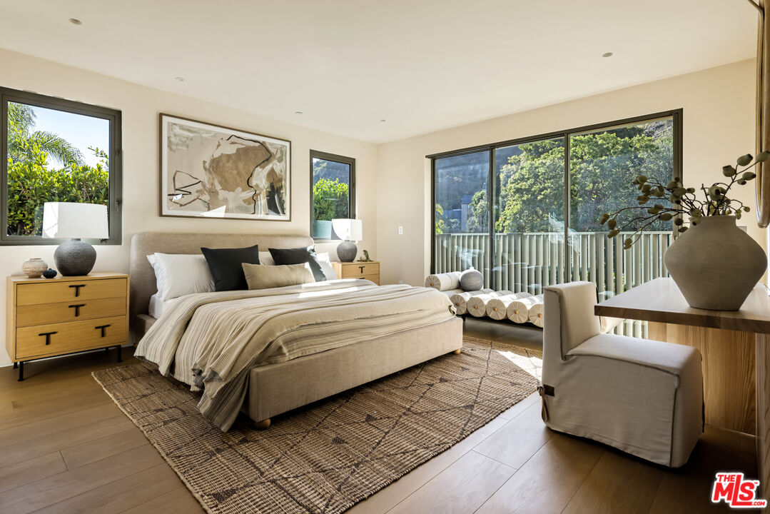 1600 Rising Glen Road Los Angeles, CA 90069 - Photo 23 of 28 a bedroom with furniture and a large window