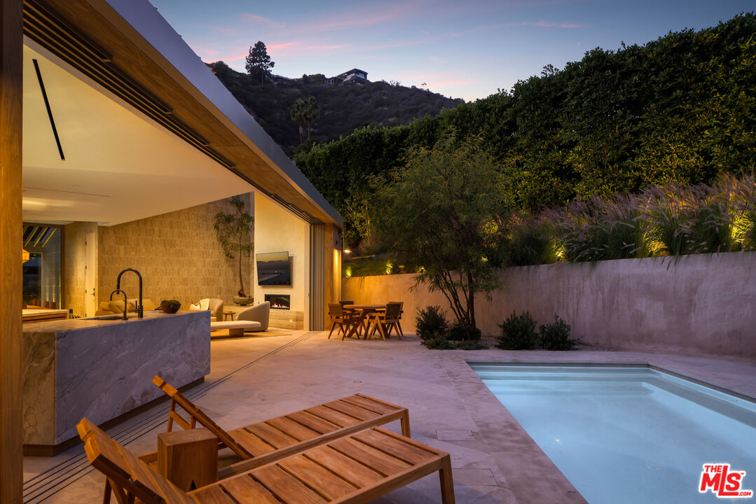 1600 Rising Glen Road Los Angeles, CA 90069 - Photo 27 of 28 a patio with yard table and chairs