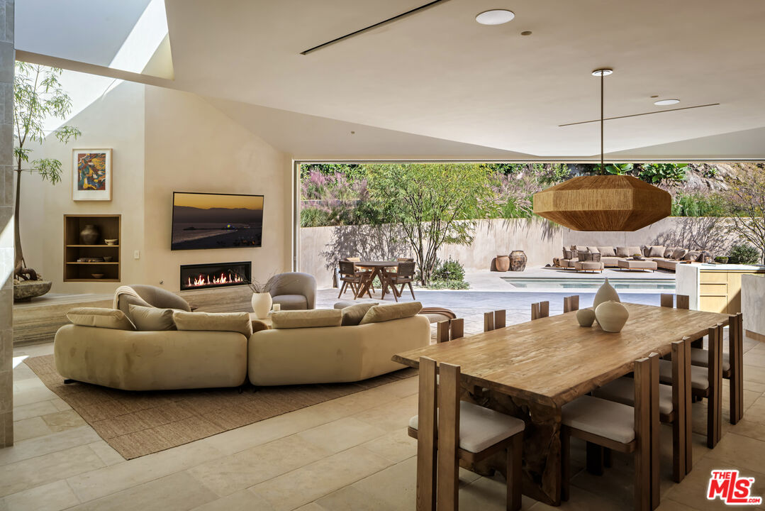 1600 Rising Glen Road Los Angeles, CA 90069 - Photo 4 of 28 a living room with furniture a fireplace and a flat screen tv