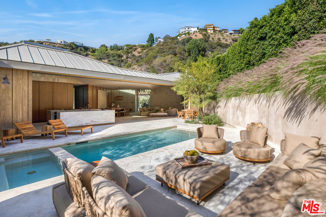 1600 Rising Glen Road Los Angeles, CA 90069 - Photo 10 of 28 a view of a patio with table and chairs potted plants and large tree