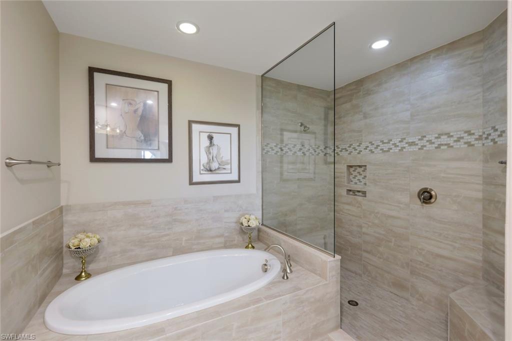 16445 Carrara Way, Unit 202 Naples, FL 34110 - Photo 11 of 35 a white bath tub sitting next to a shower