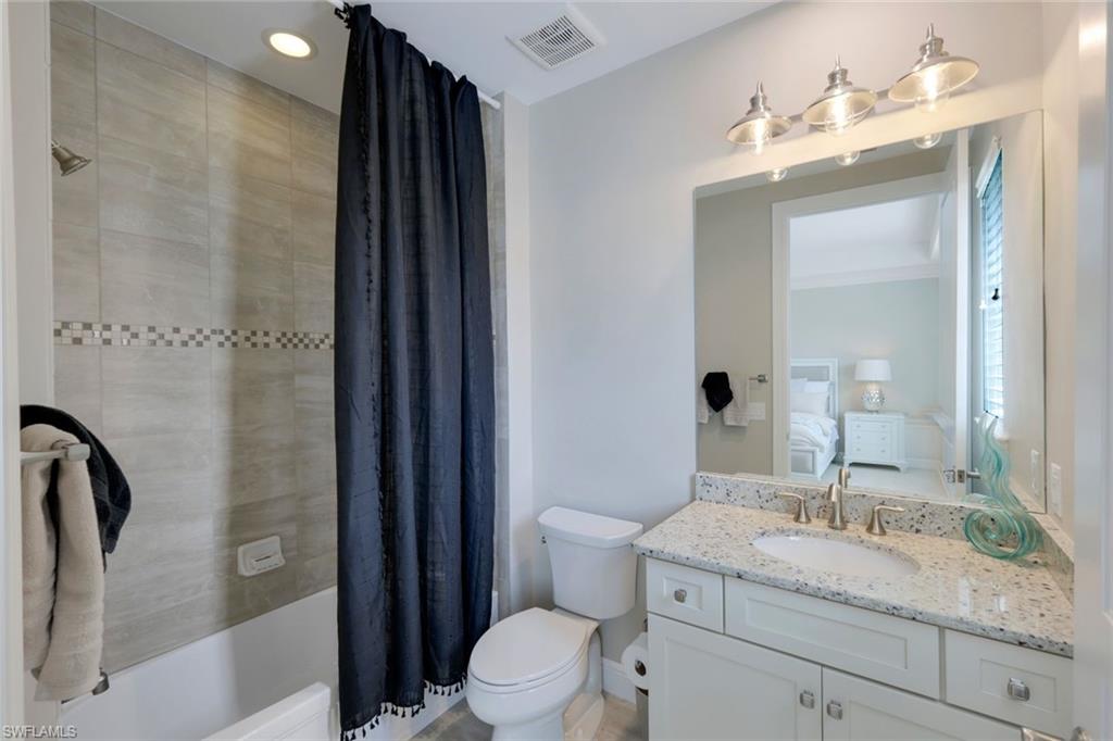 16445 Carrara Way, Unit 202 Naples, FL 34110 - Photo 13 of 35 a bathroom with a granite countertop sink toilet and shower