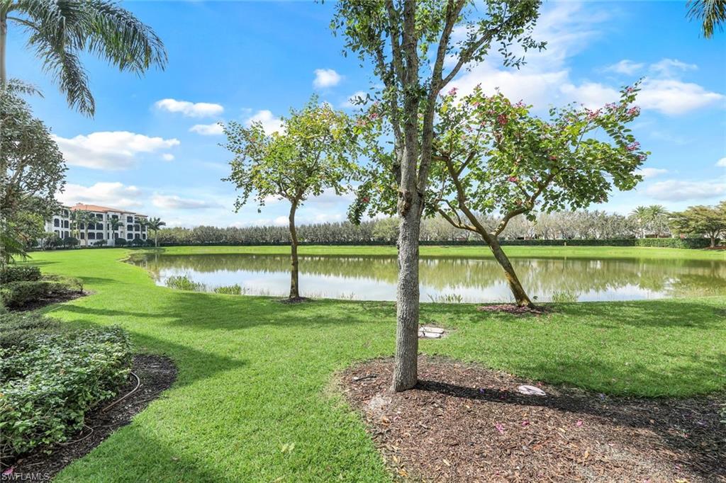16445 Carrara Way, Unit 202 Naples, FL 34110 - Photo 23 of 35 a view of a park with a lake