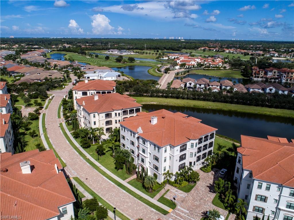 16445 Carrara Way, Unit 202 Naples, FL 34110 - Photo 25 of 35 an aerial view of residential houses with outdoor space and lake view
