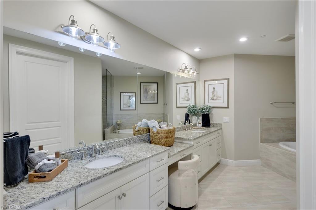 16445 Carrara Way, Unit 202 Naples, FL 34110 - Photo 10 of 35 a bathroom with a double vanity sink and a mirror